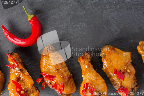 Image of fried chicken wings on a black slate plate 