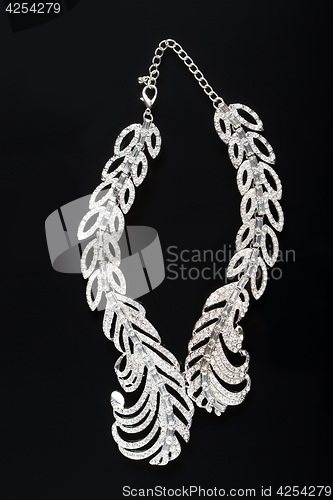 Image of necklace on a black background. gems. 