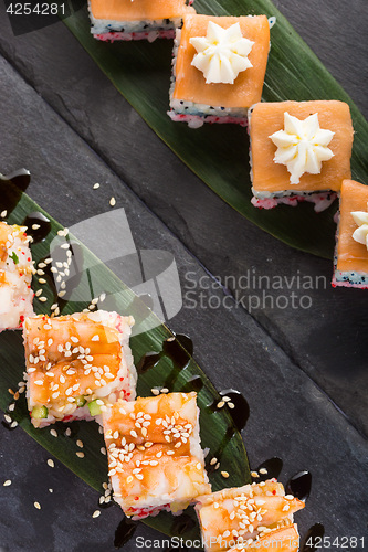 Image of set of sushi on a slate square plate. space for copy