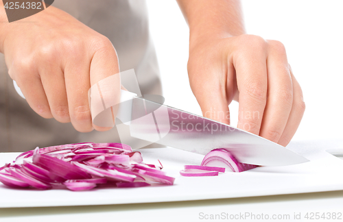 Image of Cook is chopping onion