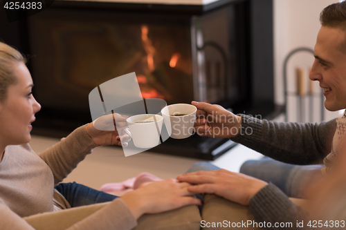 Image of Young couple  in front of fireplace