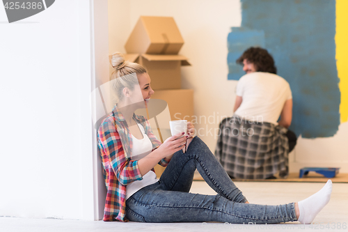 Image of young couple doing home renovations