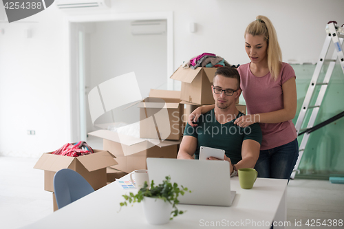 Image of Young couple moving in a new home