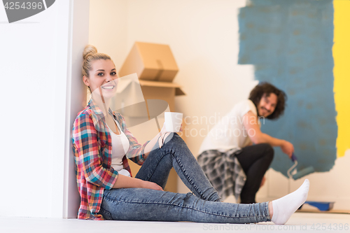 Image of young couple doing home renovations