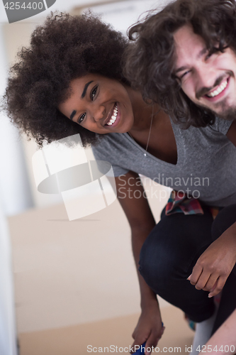 Image of multiethnic couple renovating their home