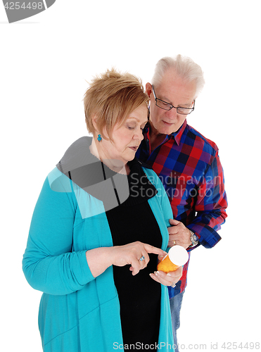 Image of Wife showing husband his pills.