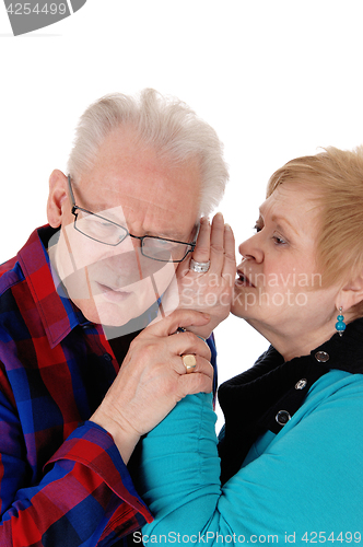 Image of Wife whisper in husband ear.