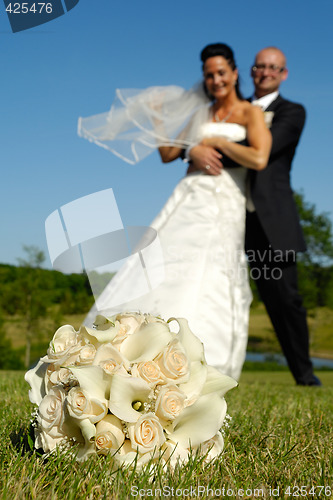 Image of Bouquet and wedding couple