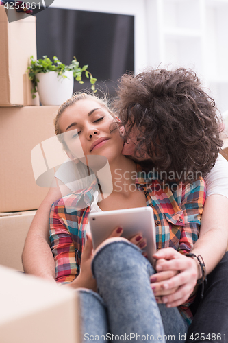 Image of young couple moving  in new house