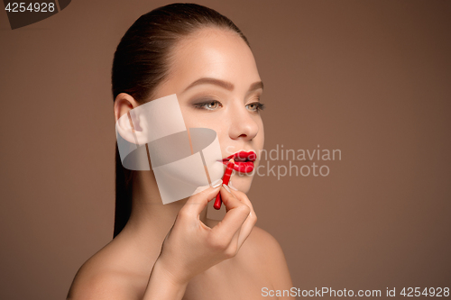 Image of Beautiful female lips with make-up and brush