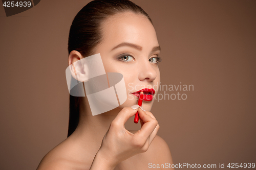 Image of Beautiful female lips with make-up and brush