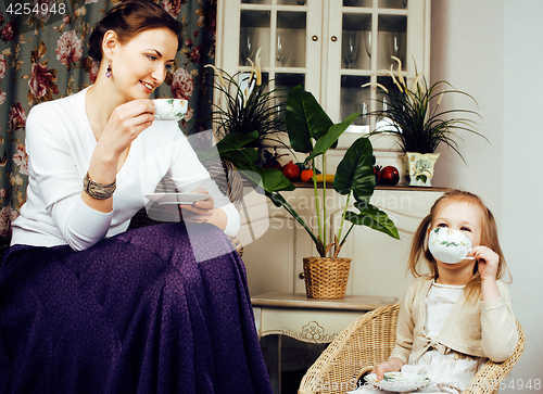 Image of young mother with daughter at luxury home interior vintage