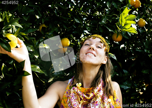 Image of pretty islam woman in orange grove smiling, real muslim girl che