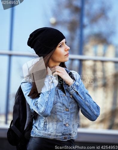 Image of young pretty girl near business building walking