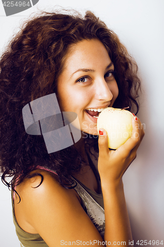 Image of pretty young real tenage girl eating apple close up smiling