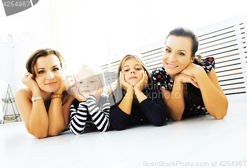 Image of Mature sisters twins at home with little daughter, happy family 