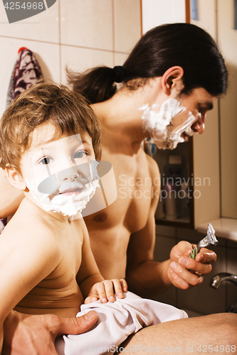 Image of Portrait of son and father enjoying while shaving together, lifestyle people concept, happy family 