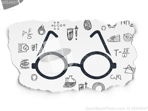 Image of Science concept: Glasses on Torn Paper background