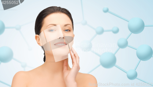Image of beautiful young woman face with molecules