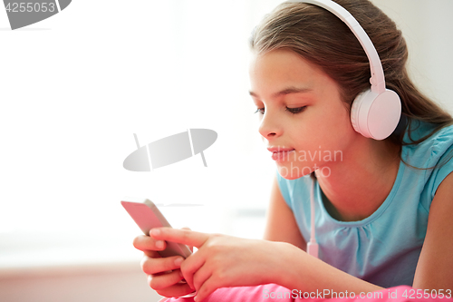 Image of close up of girl with smartphone and headphones