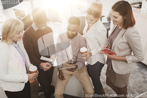 Image of business team with tablet pc and coffee at office
