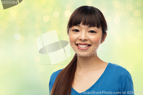 Image of happy smiling young asian woman
