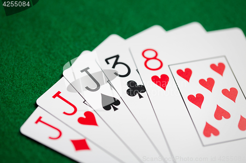 Image of poker hand of playing cards on green casino cloth