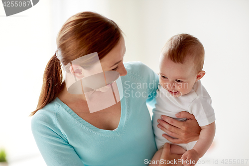 Image of happy young mother with little baby at home