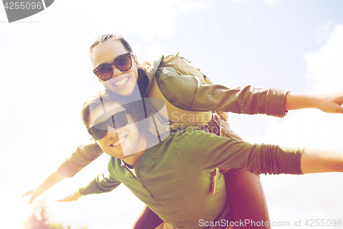 Image of happy couple with backpacks having fun outdoors