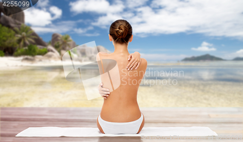 Image of beautiful woman with bare top on beach