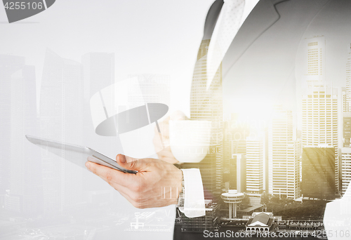 Image of close up of businessman with tablet pc and coffee