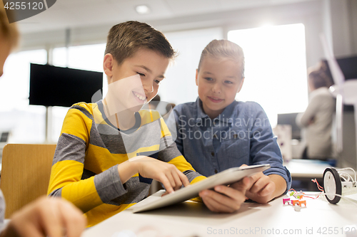 Image of kids with tablet pc programming at robotics school