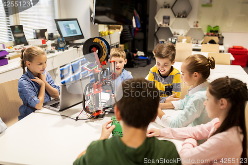 Image of happy children with 3d printer at robotics school