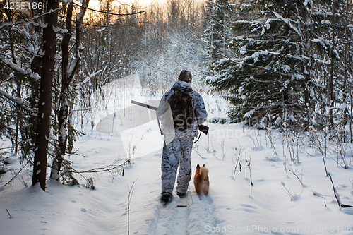 Image of hunter comes out of the winter forest