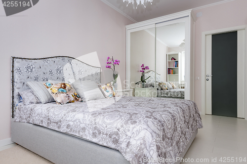 Image of elegant bedroom in soft light colors