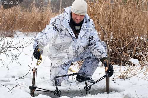 Image of hunter putting a trap