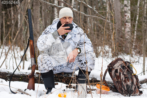 Image of hunter during the rest on winter hunting