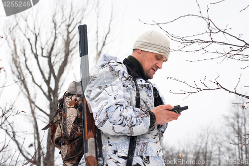 Image of hunter looking on the mobile  navigation device