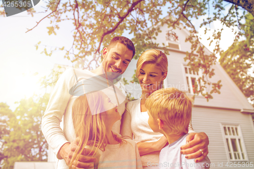 Image of happy family in front of house outdoors