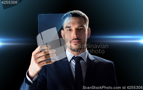 Image of businessman working with transparent tablet pc