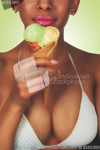 Image of young black beautiful woman eating ice-cream