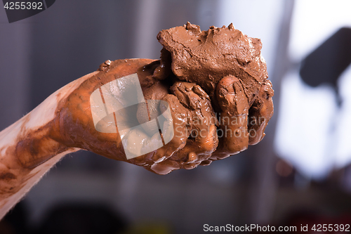 Image of hands of a potter with clay, closeup