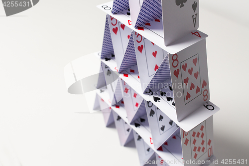 Image of house of playing cards over white background