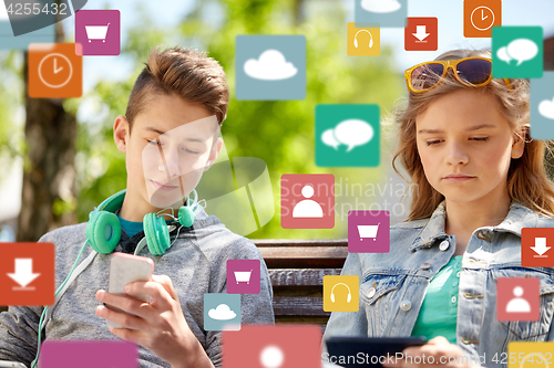 Image of teenage friends with gadgets outdoors