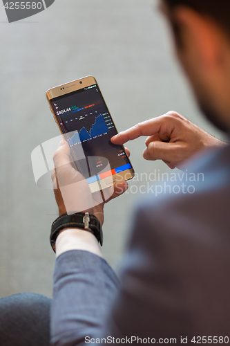 Image of Close up of businessman using mobile smart phone.