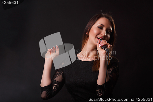 Image of Girl in dress with microphone