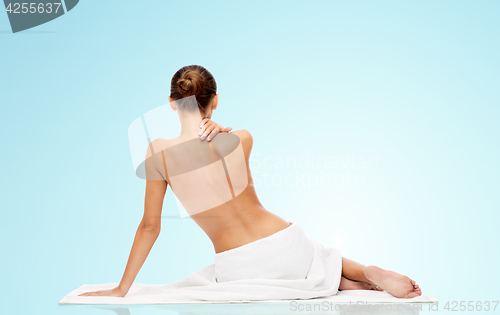 Image of beautiful young woman in white towel with bare top