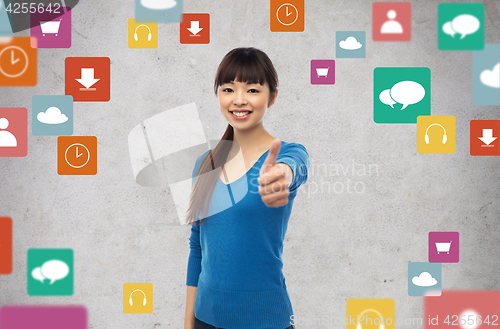 Image of happy smiling young woman showing thumbs up