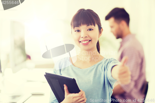 Image of happy creative female office worker with tablet pc