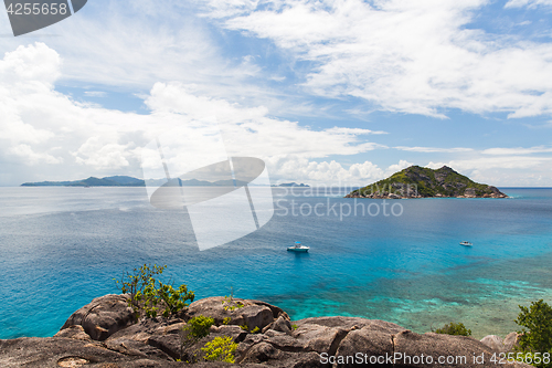 Image of island and boats in indian ocean on seychelles